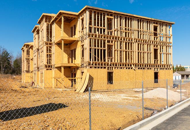 a close-up of temporary chain link fences enclosing a job site, signaling progress in the project's development in Manchester, CT